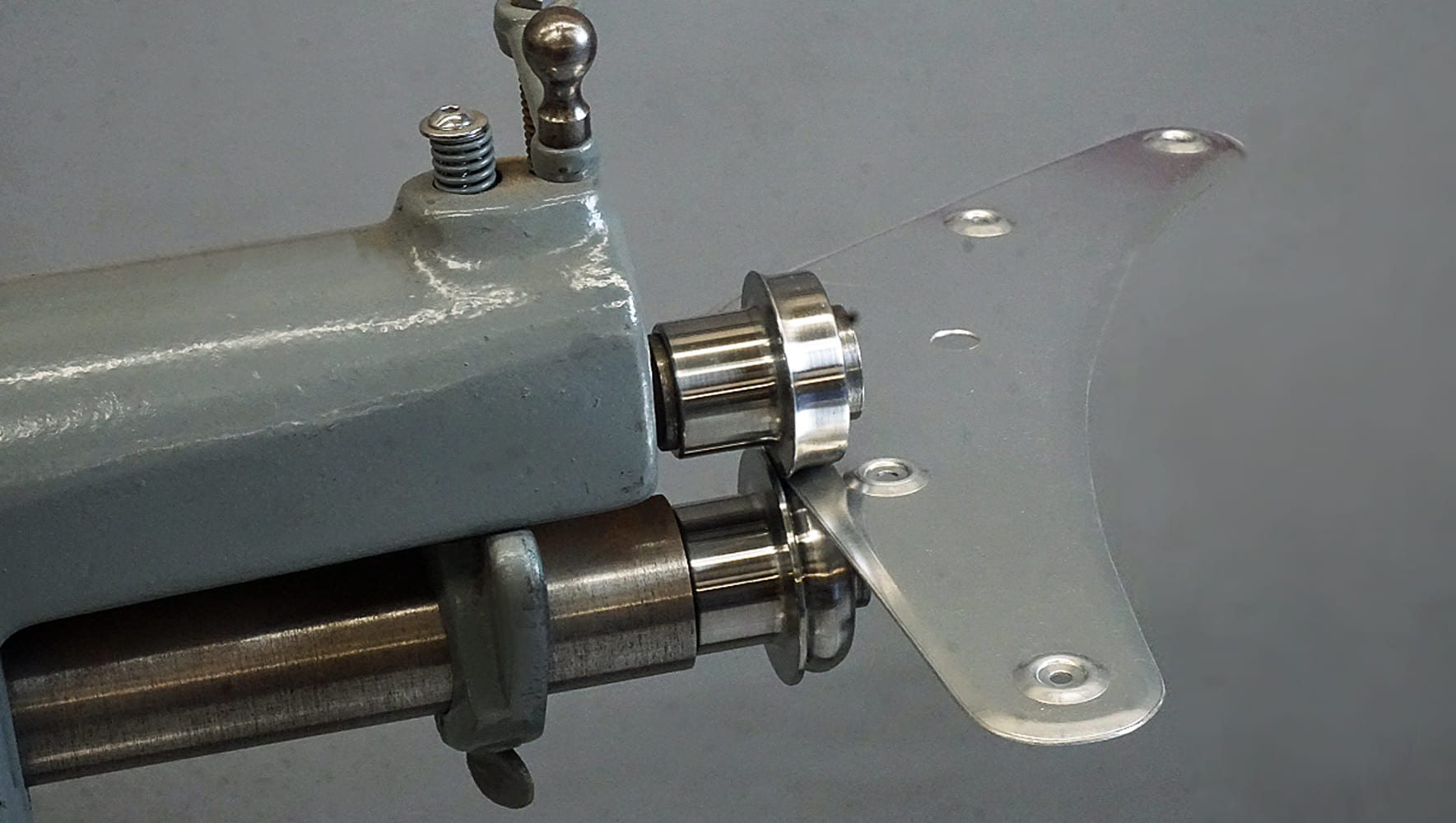 16 Completed metal panel with dimpled holes being finished on a bead roller