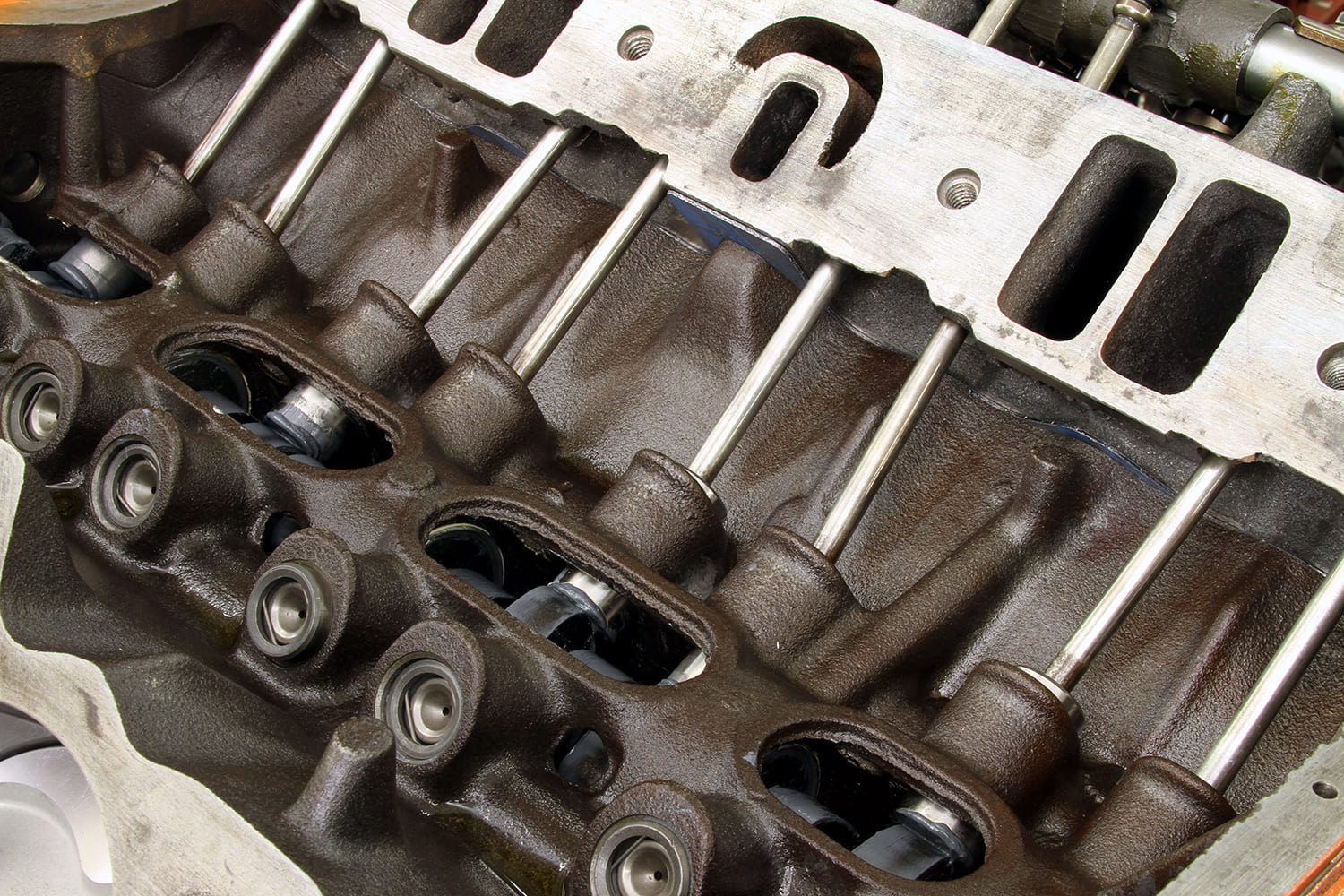 17 Pushrods and lifters installed in Mopar 340 valley visible through intake opening