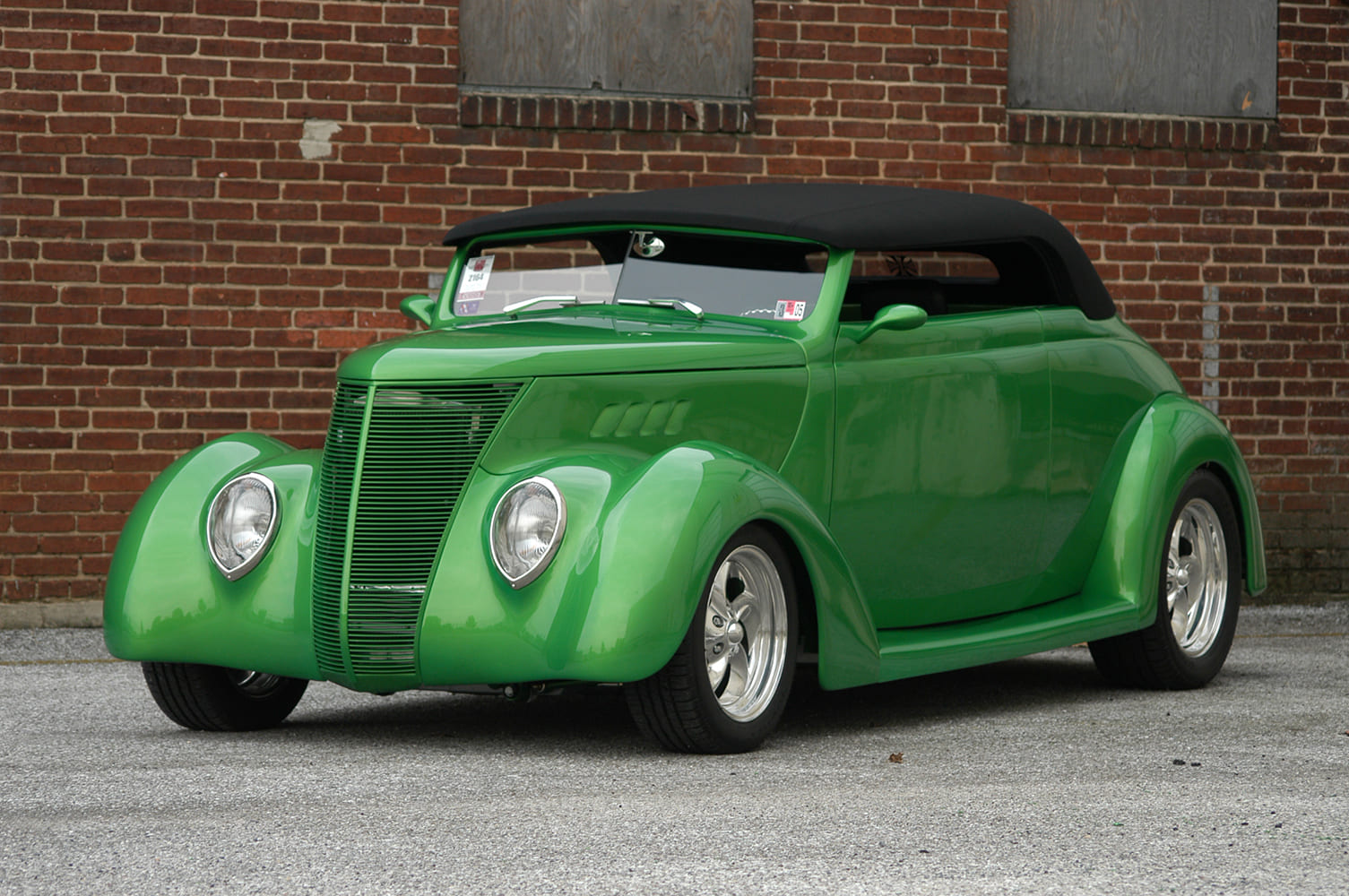 19 1937 Ford Roadster with modernized black soft top billet wheels and smoothed body panels in vibrant green