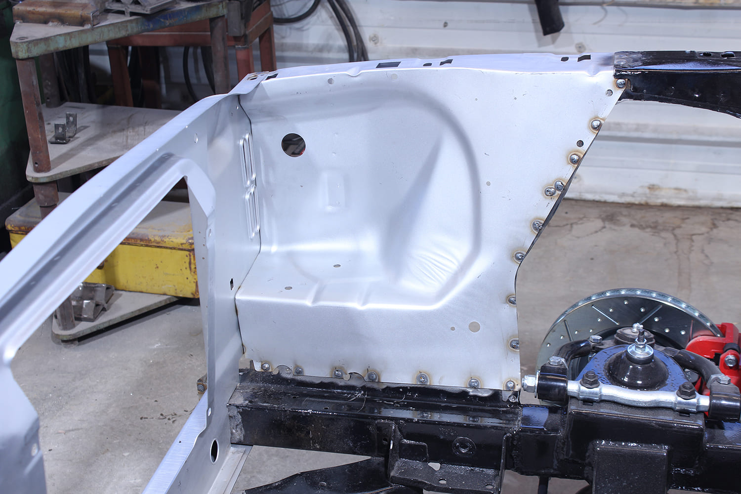 19 New apron panel plug welded in place on Mustang chassis with visible tack welds and alignment