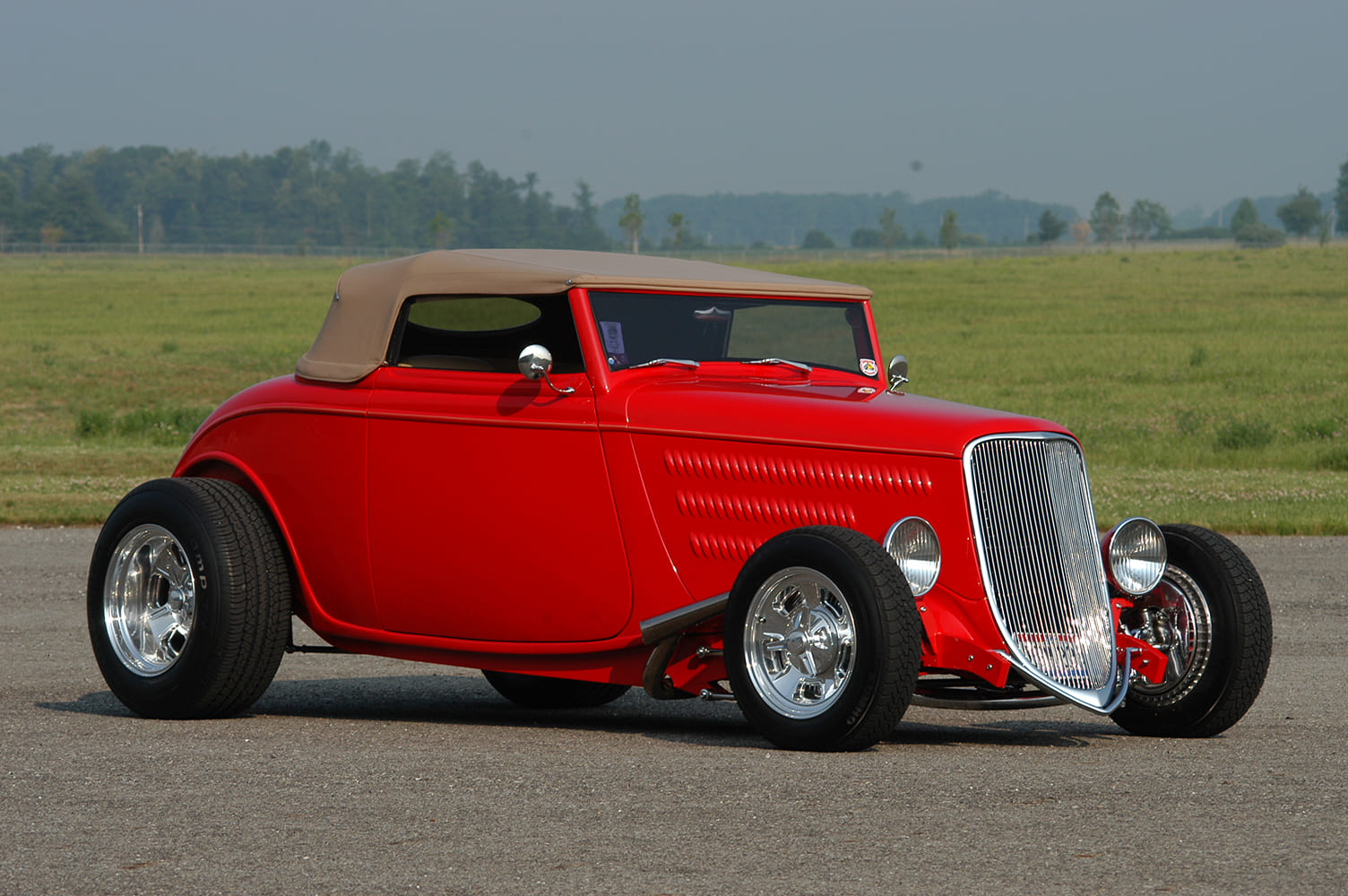 21 1933 Ford Roadster with tan top polished five spokes and punched louvers on the hood sides