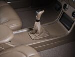 21 1959 Chevy Impala interior features custom tan leather seats and a modern Pioneer touchscreen in the center console