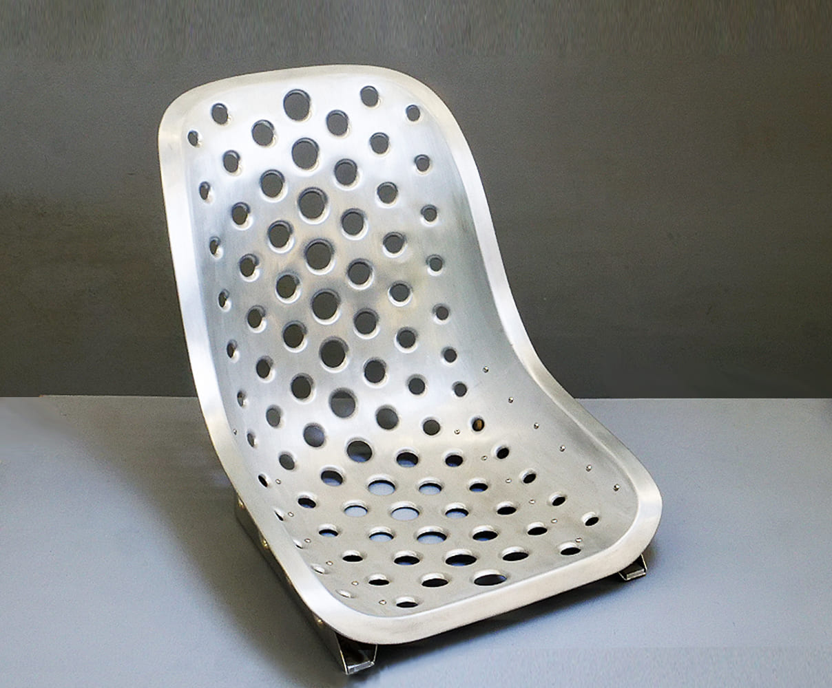 21 Custom fabricated aluminum racing seat with a perforated design for weight reduction