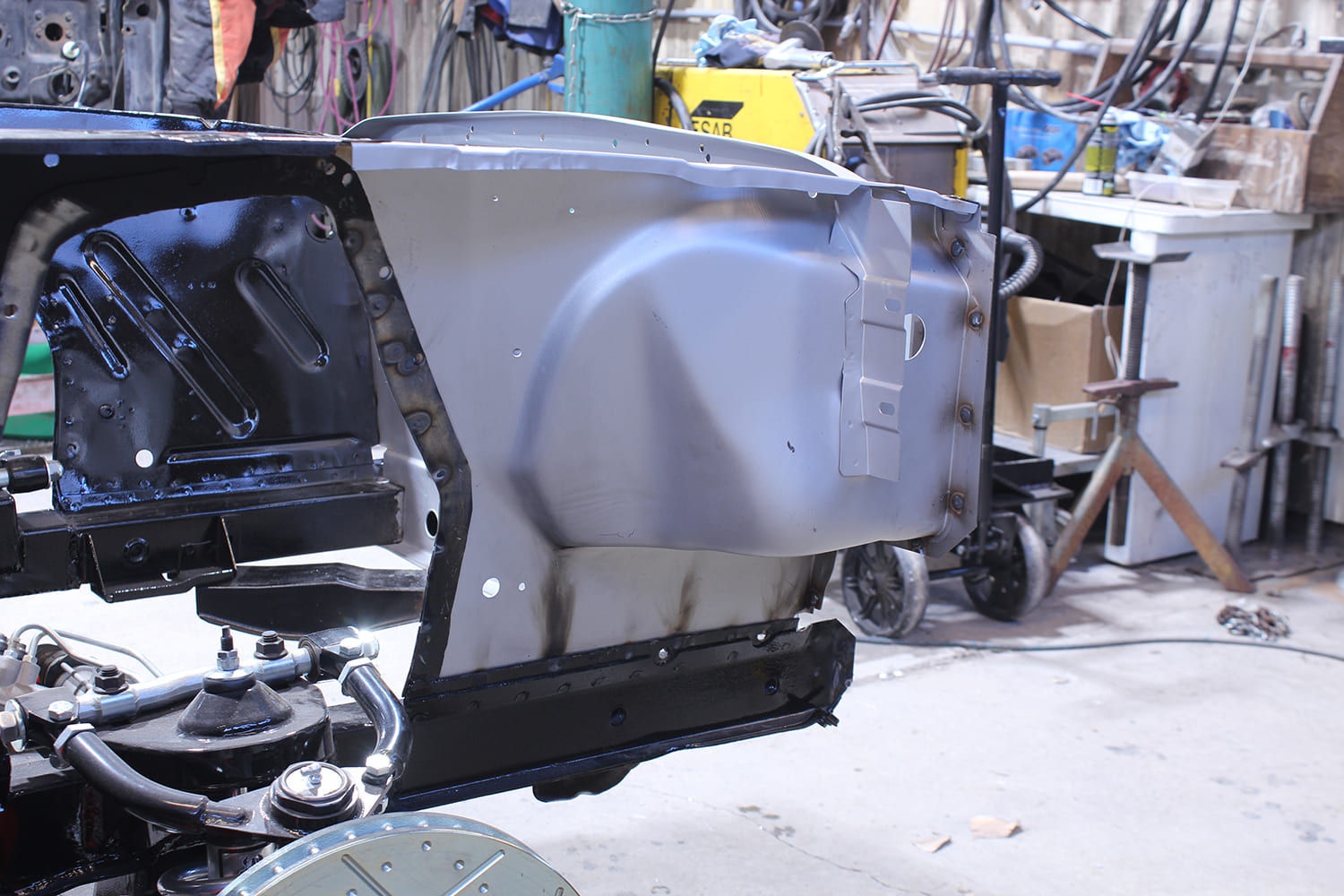 21 Newly installed driver side apron on 1965 66 Mustang with spot welds and fresh primer coat