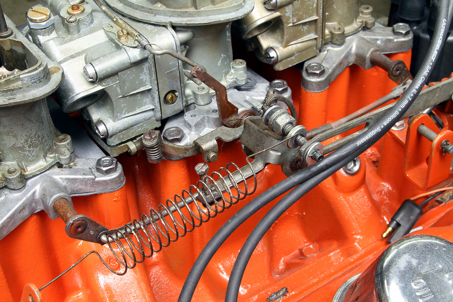22 Close up of Mopar 340 throttle linkage and return spring on Six Pack intake