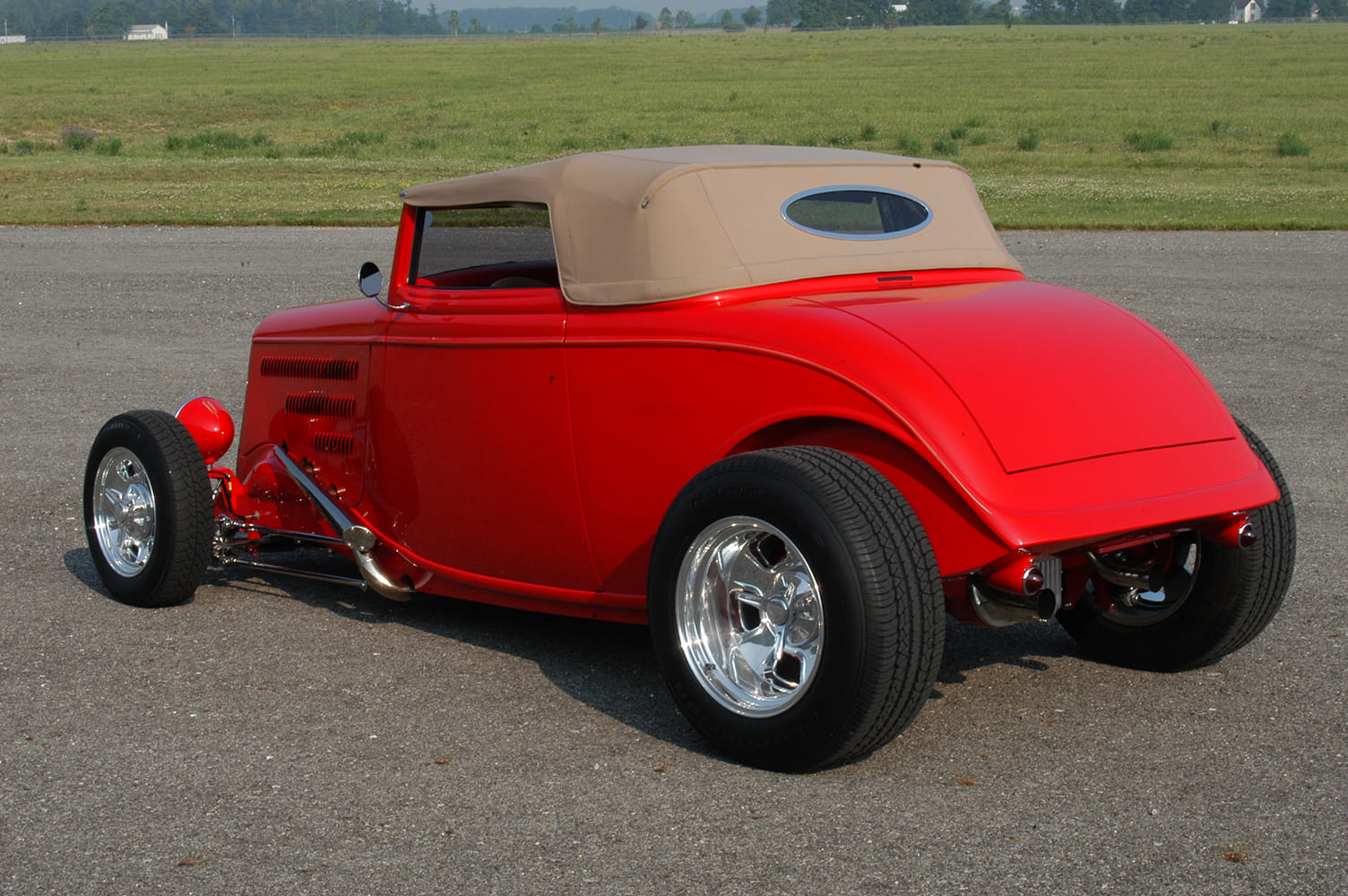 22 Rear view of 1933 Ford Roadster with chopped tan top oval rear window and smooth tail panel