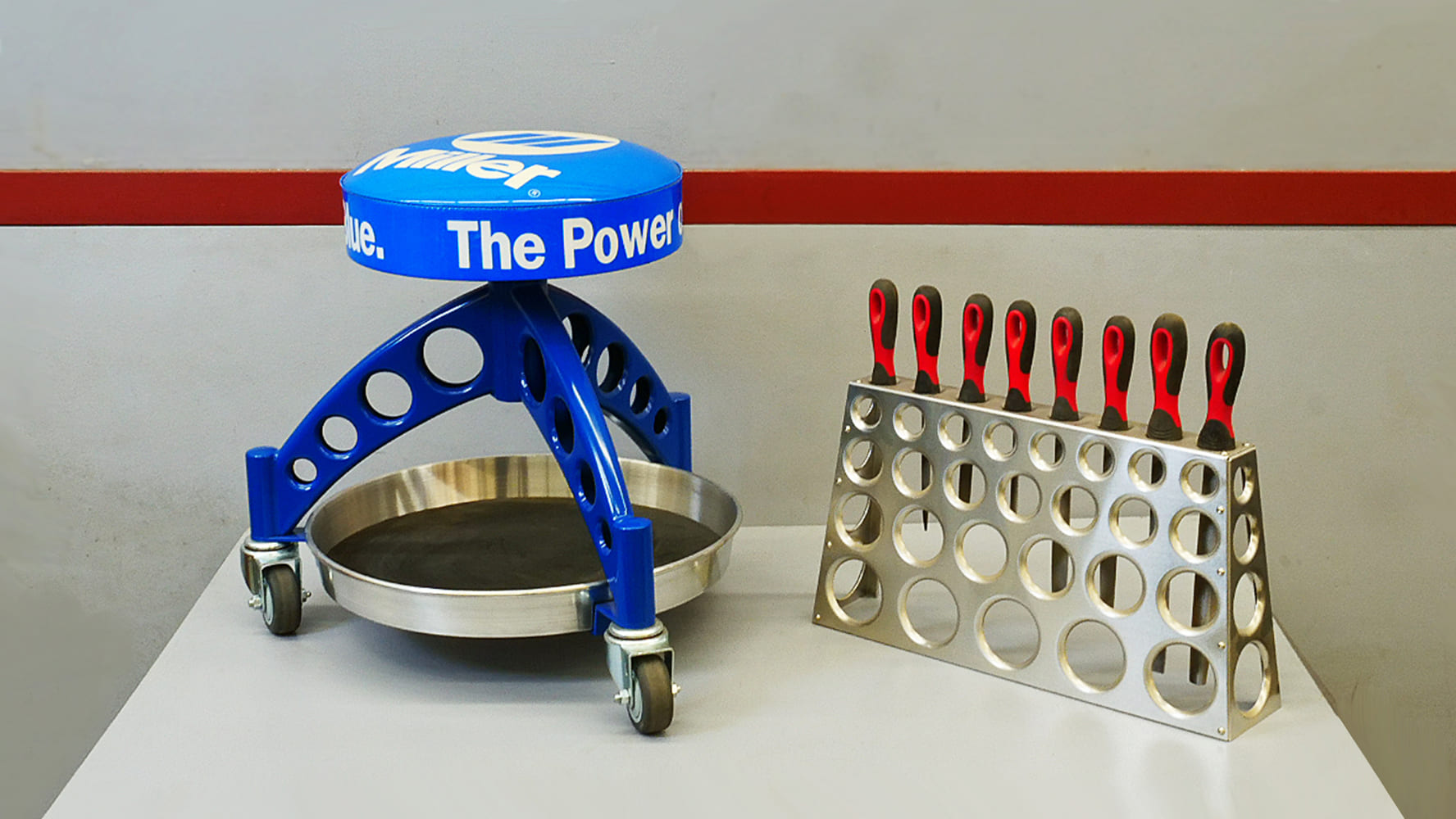 24 Custom rolling shop stool with a dimpled aluminum tool holder for organization