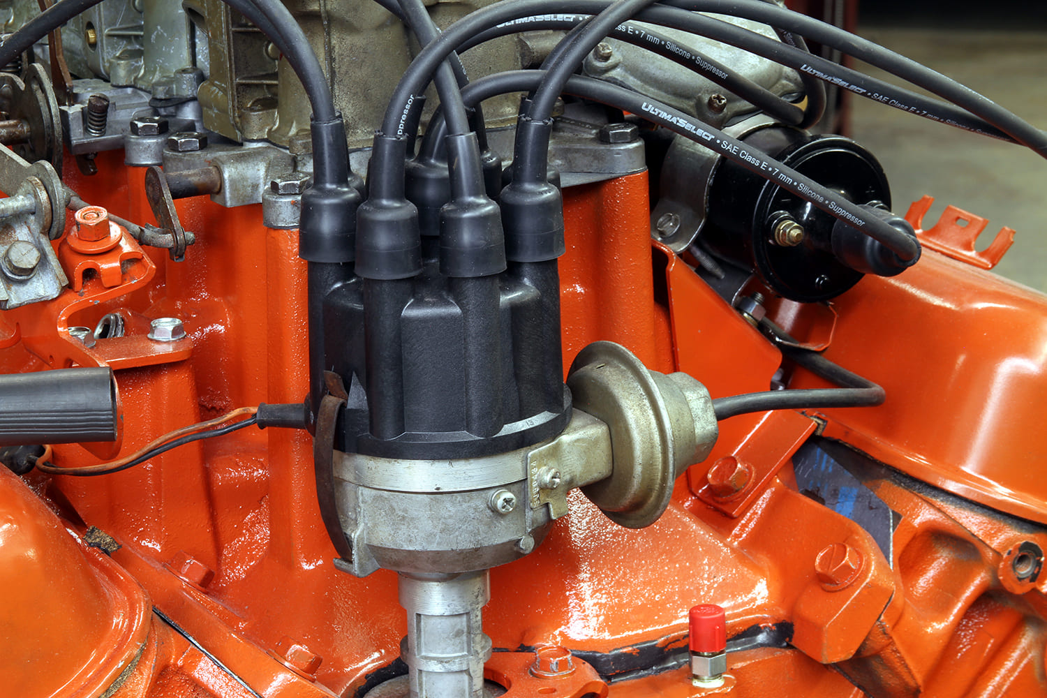 24 Mopar 340 distributor and coil installed with vacuum advance visible on driver s side