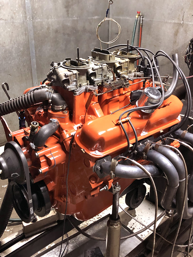 27 Mopar 340 Six Pack engine on dyno test stand with Hooker style headers and triple Holley carburetors