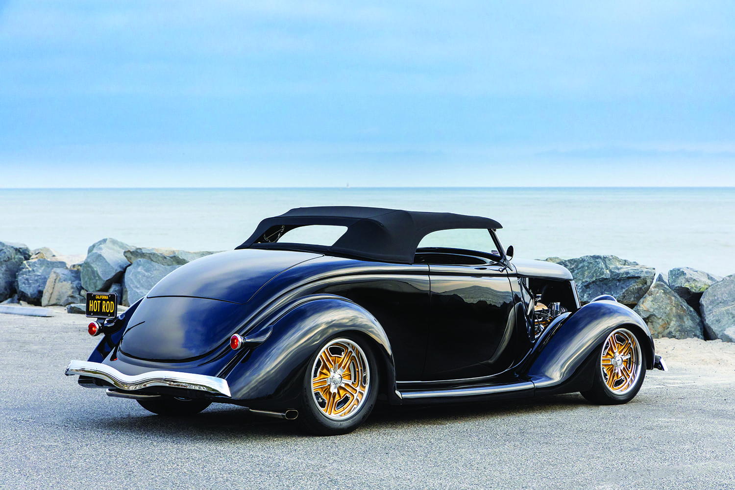 28 36 Cabriolet showing sculpted fenders and raked stance by the coast