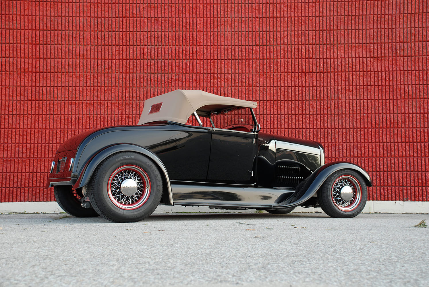 29 1930 Ford Roadster with tan top wire wheels and black fenders in a traditional street rod style