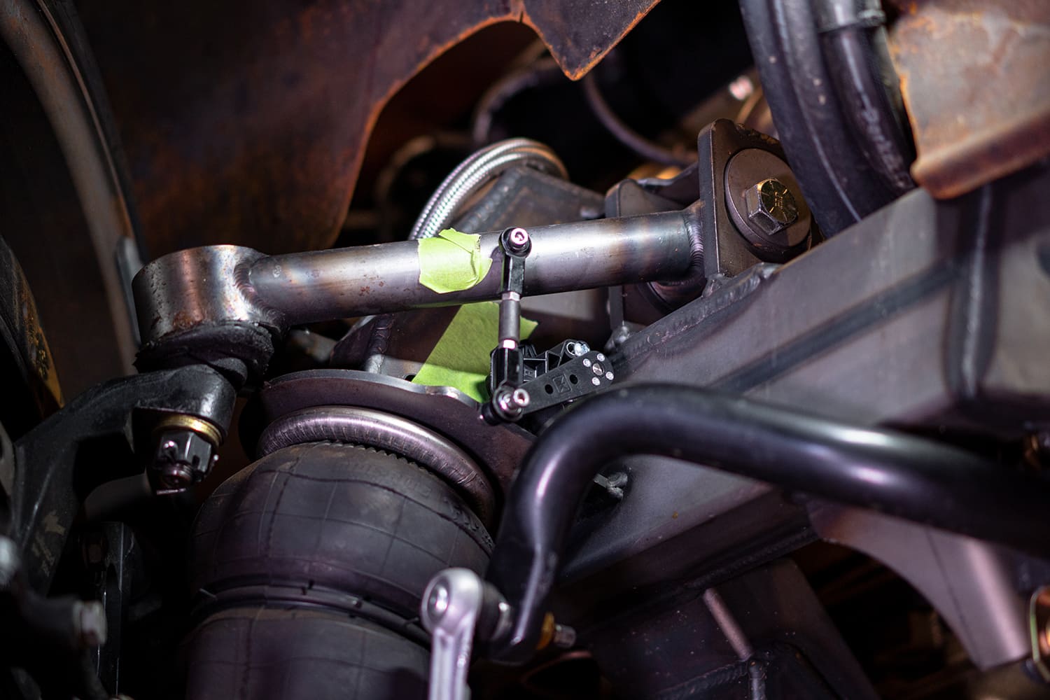 36 Rear height sensor installed on the 4 link bar with green tape mockup