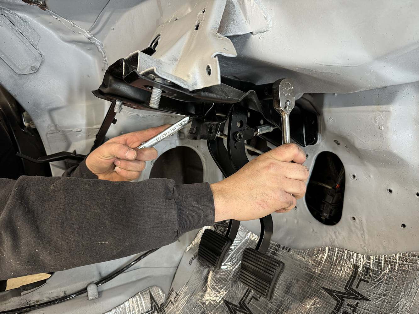 006 1971 Camaro dual pedal assembly being torqued into place under dash