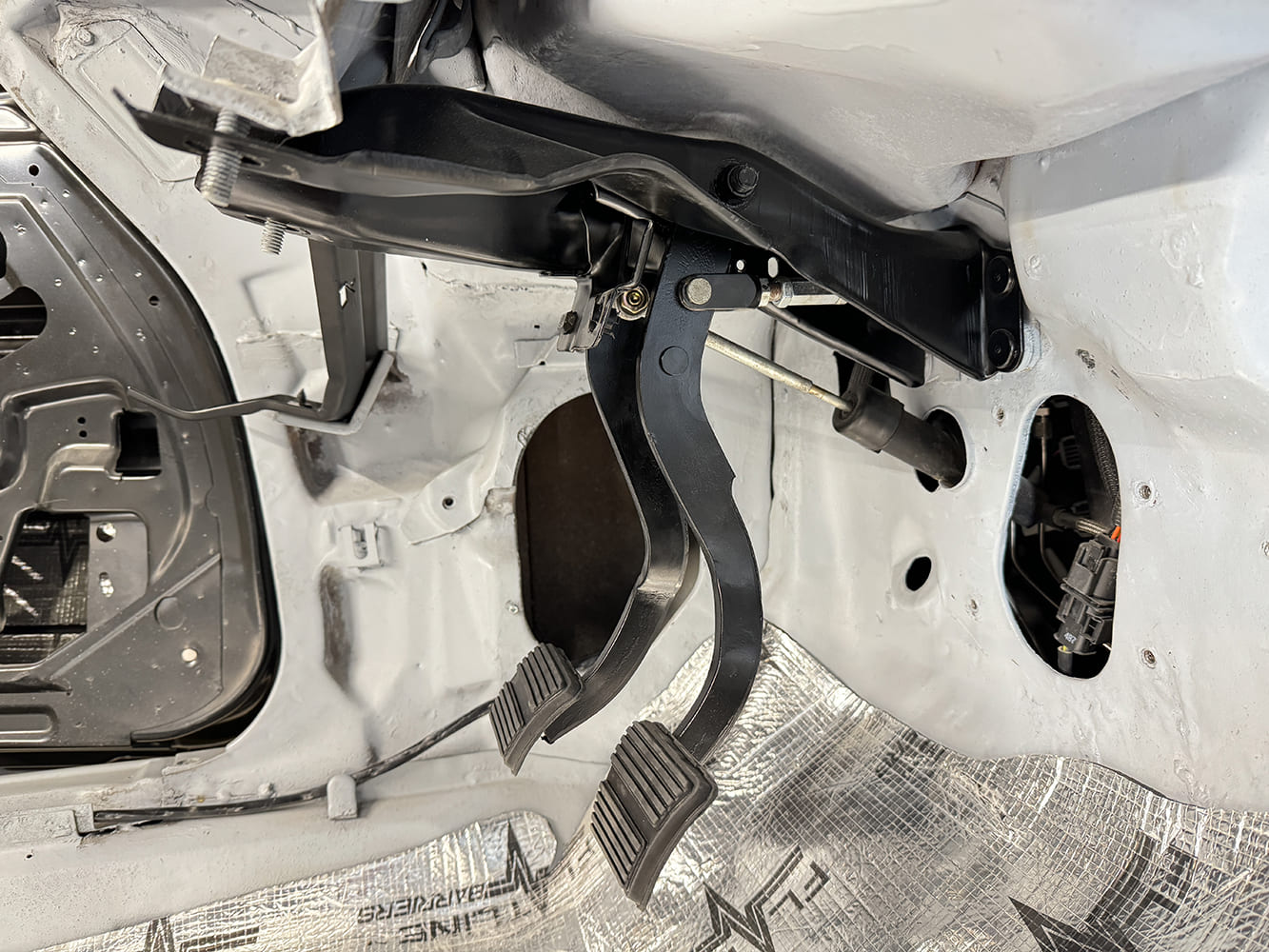 007 1971 Camaro clutch and brake pedals mounted inside raw interior tub