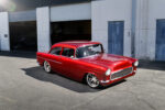 01 1955 Chevy Custom in candy red with smoothed body lines and modern stance on large polished wheels