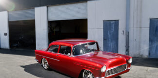 01 1955 Chevy Custom in candy red with smoothed body lines and modern stance on large polished wheels