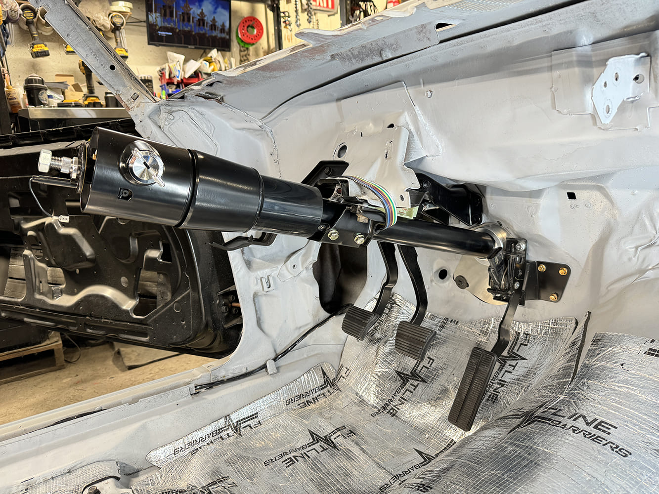 014 1971 Camaro interior showing mounted steering column with full clutch brake and gas pedals