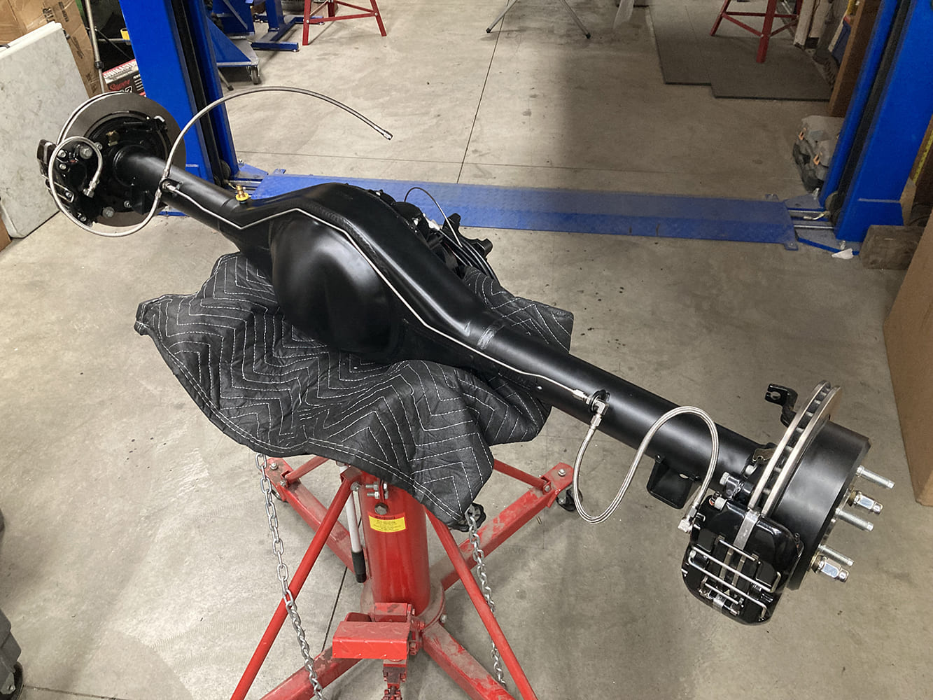 015 Rear axle fitted with stainless lines and Wilwood calipers prepped for installation