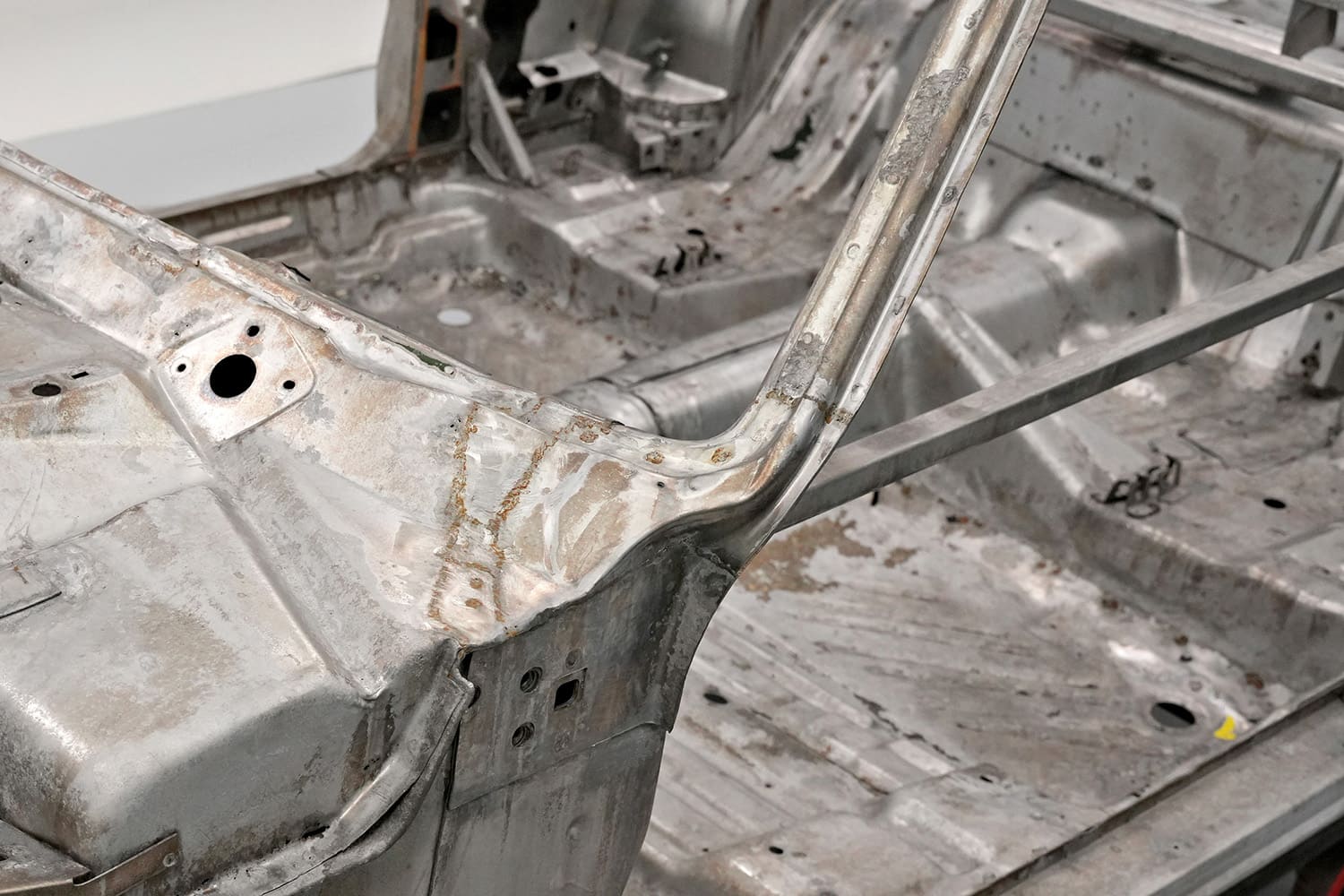 02 interior view of stripped 1971 challenger showing rusted pillar and bare metal floor