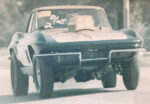 020 Vintage photo of early 1960s drag spec Corvette launching hard with period hood scoop and raised front