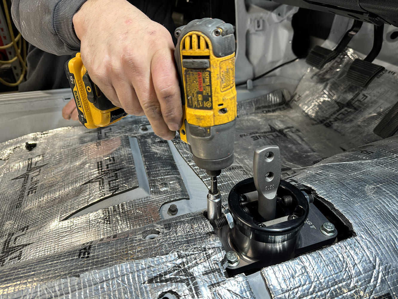 022 1971 Camaro shifter bolted to tunnel using DeWalt impact and black hardware