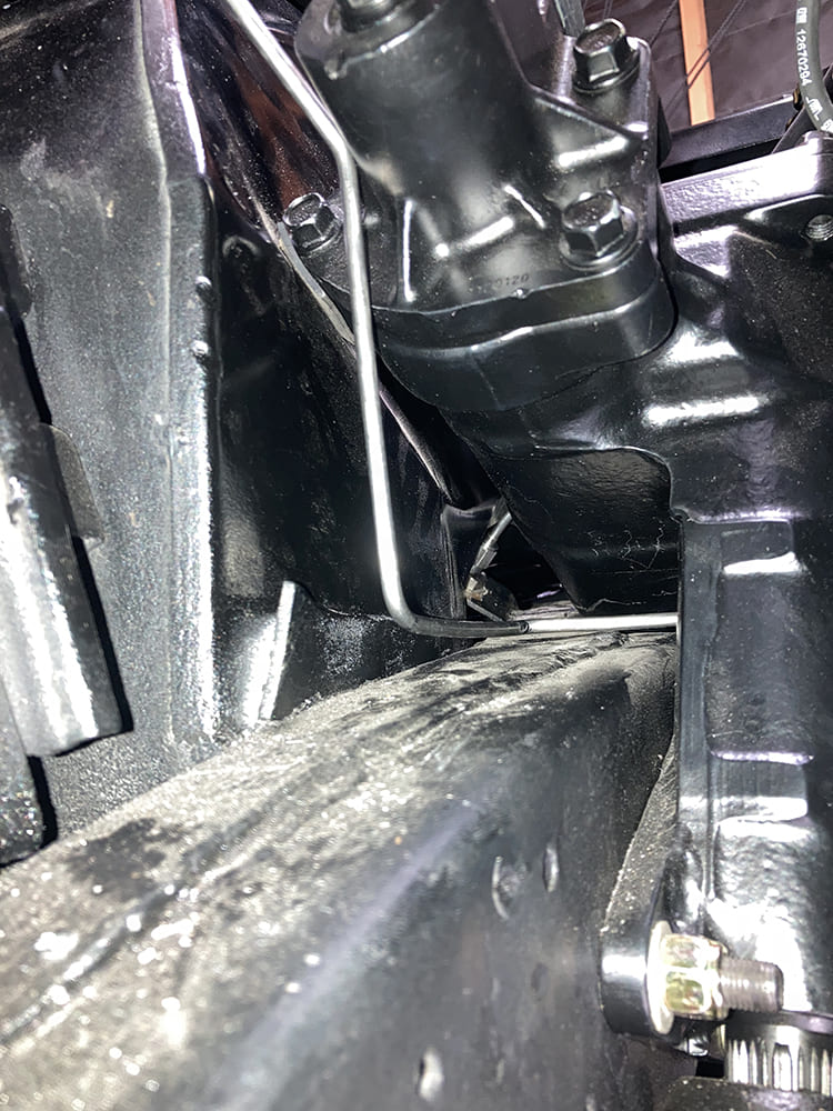 025 Steering box area with brake lines snaking tightly along inner frame structure