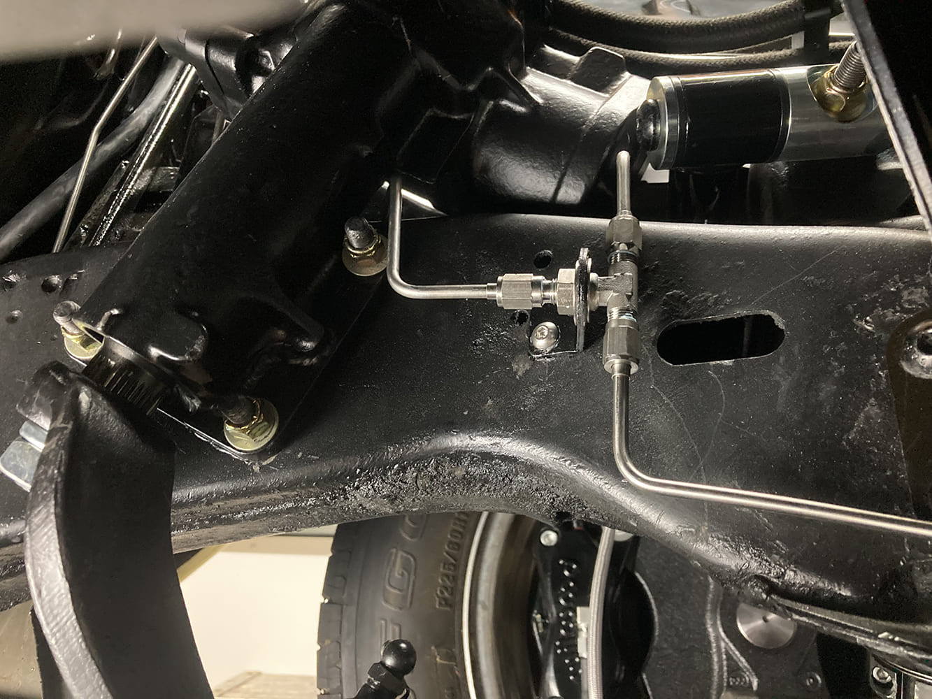026 Stainless brake junction block mounted to frame with dual outlet lines