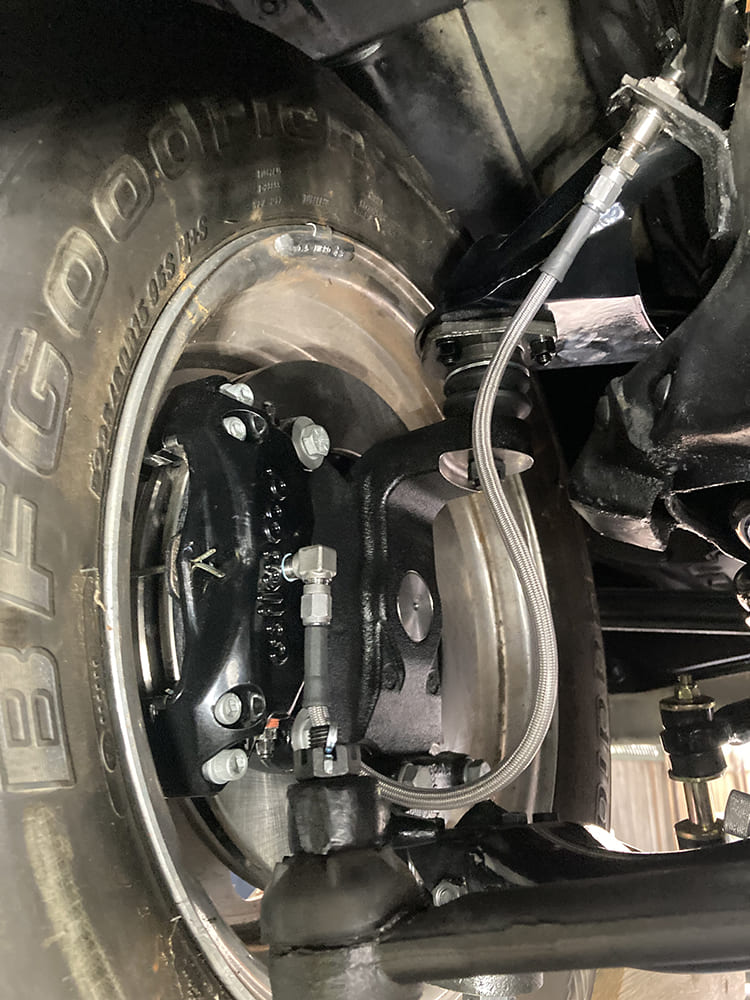 027 Braided front brake hose routed to caliper with AN fittings and stainless support