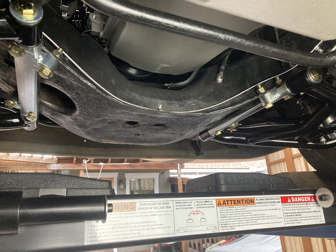 028 Stainless hardline curves precisely under control arm on reinforced bracket