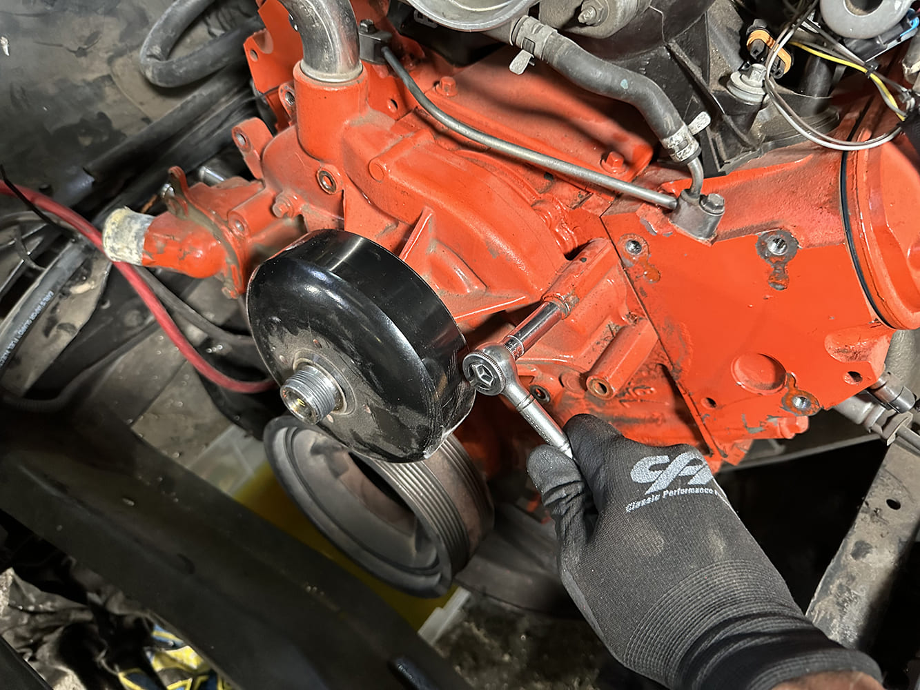 03 Water pump bolts being removed to prep for accessory system install