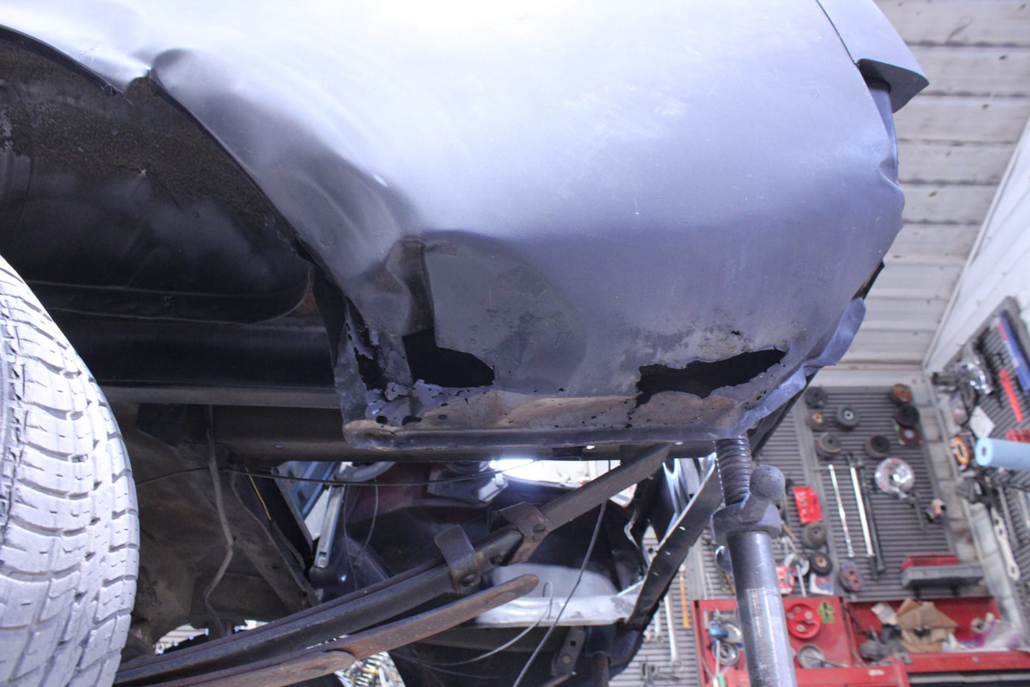 04 1965 Mustang lower quarter rust damage close up before patch