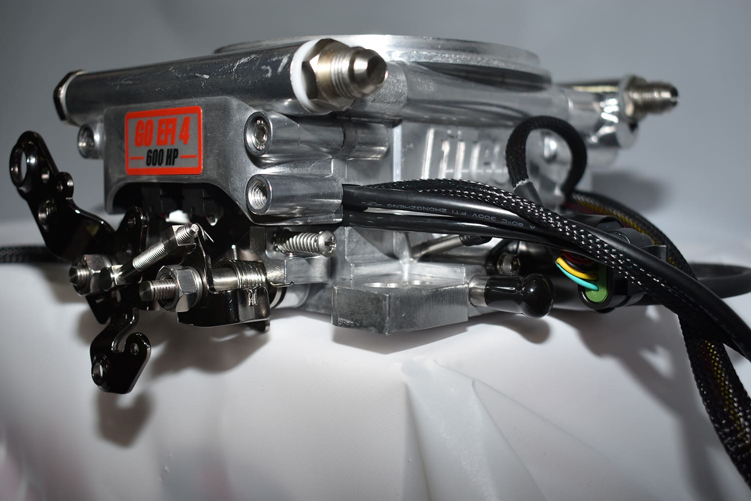 04 Rear view of polished FiTech Go EFI 4 showing dual fuel inlet ports and throttle linkage