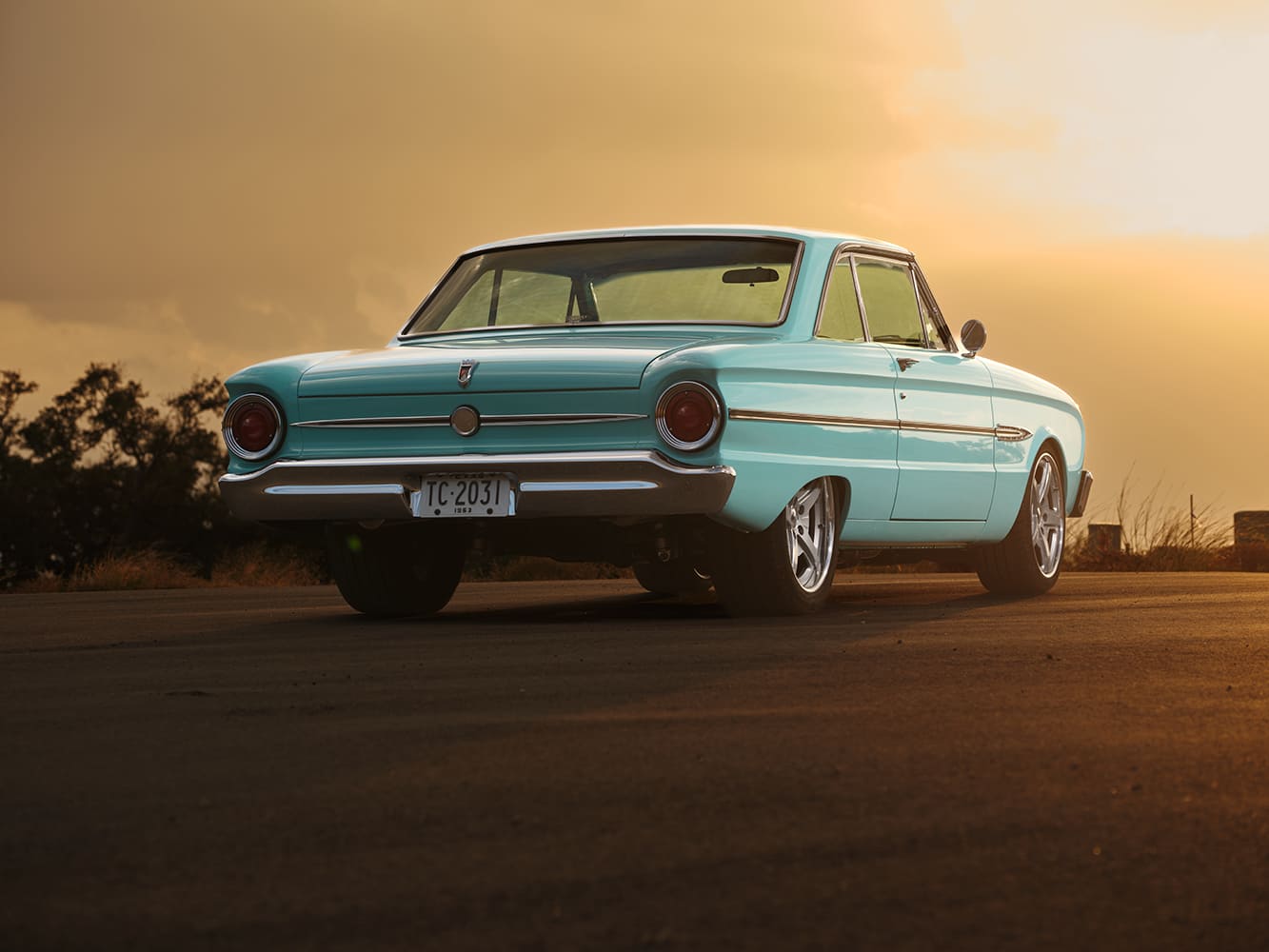 06 1963 Ford Falcon rear quarter with clean turquoise body lines and custom wheels