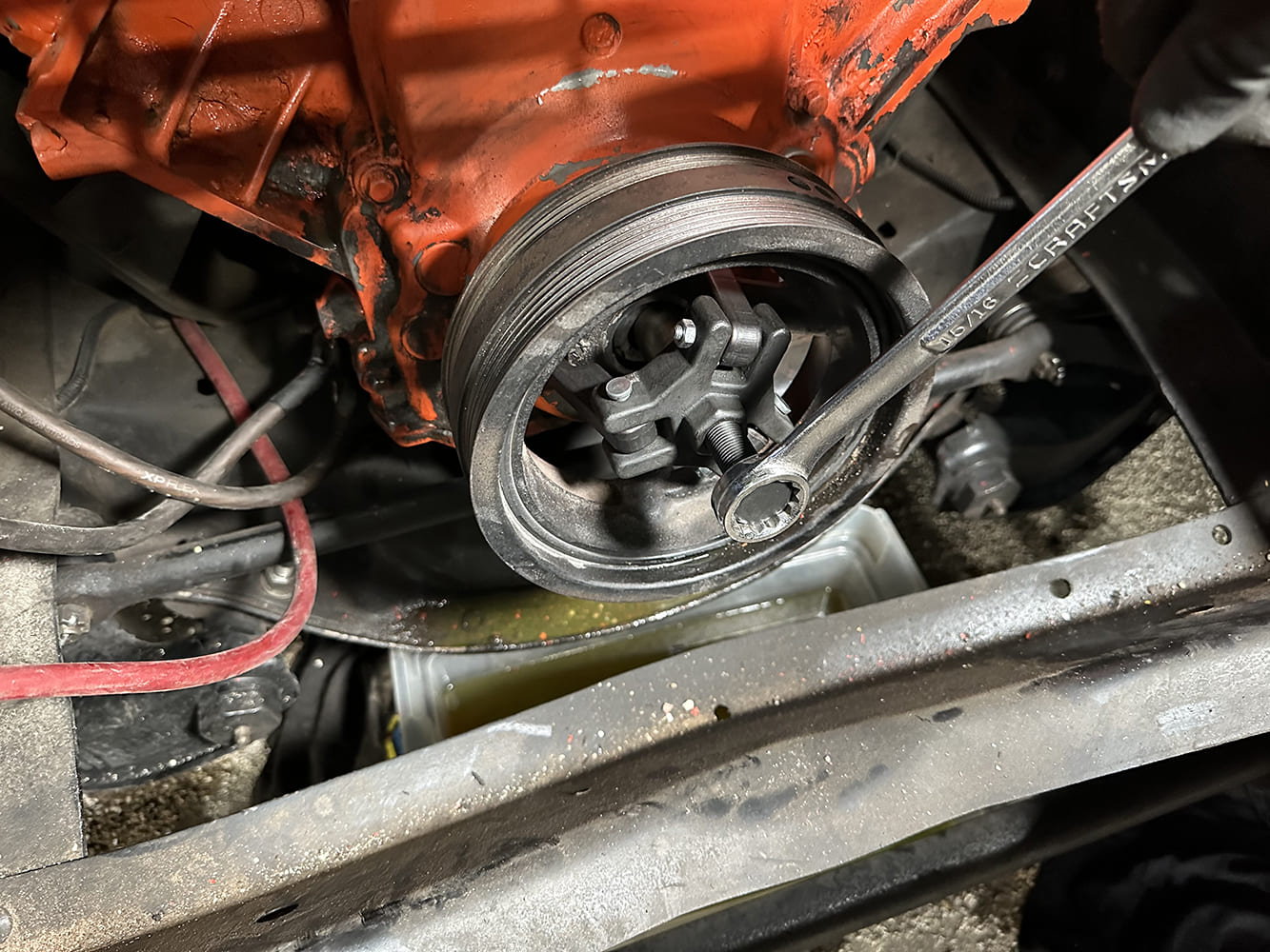 06 Harmonic balancer being pulled with a jaw puller during teardown
