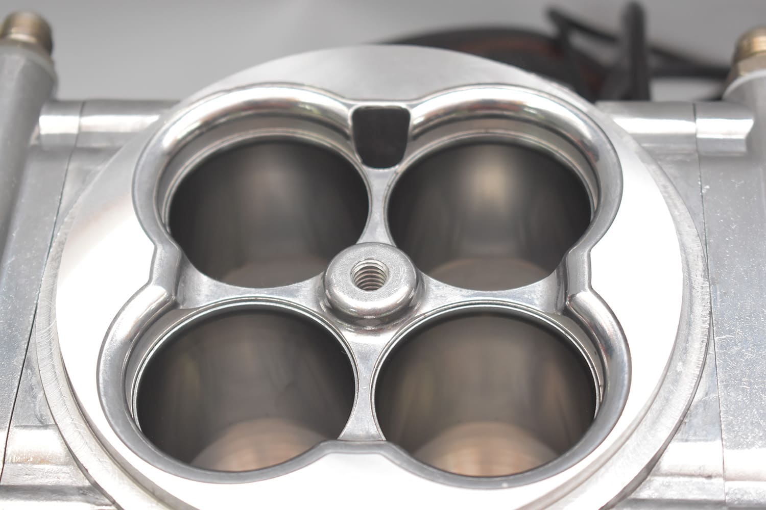 06 Top view of polished EFI throttle body revealing four venturis with smooth bore finish