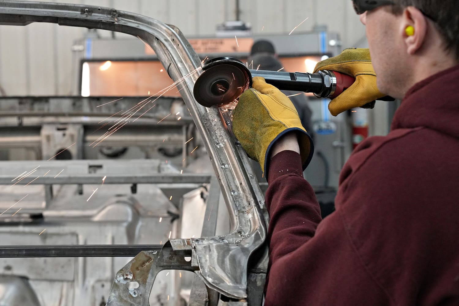 06 technician using cutoff wheel to remove damaged pillar section on 1971 challenger