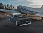 08 1960 Ford custom crew cab lowered blue truck parked beside old DC 3 aircraft