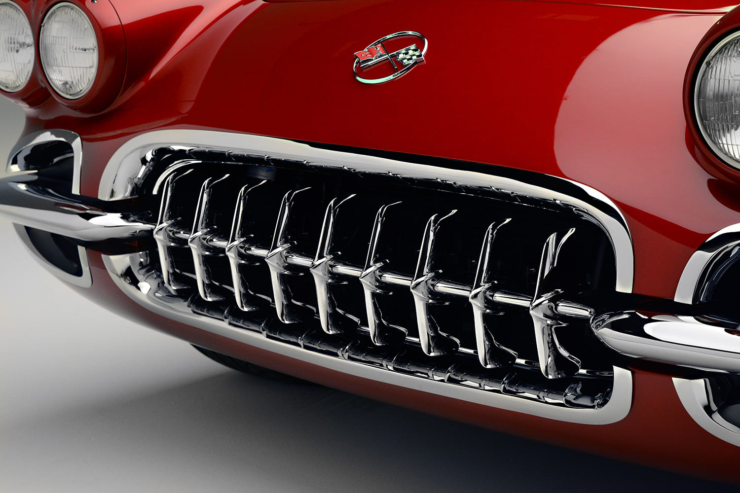 09 1962 Corvette grille showcases classic shark tooth chrome design under a cross flags emblem