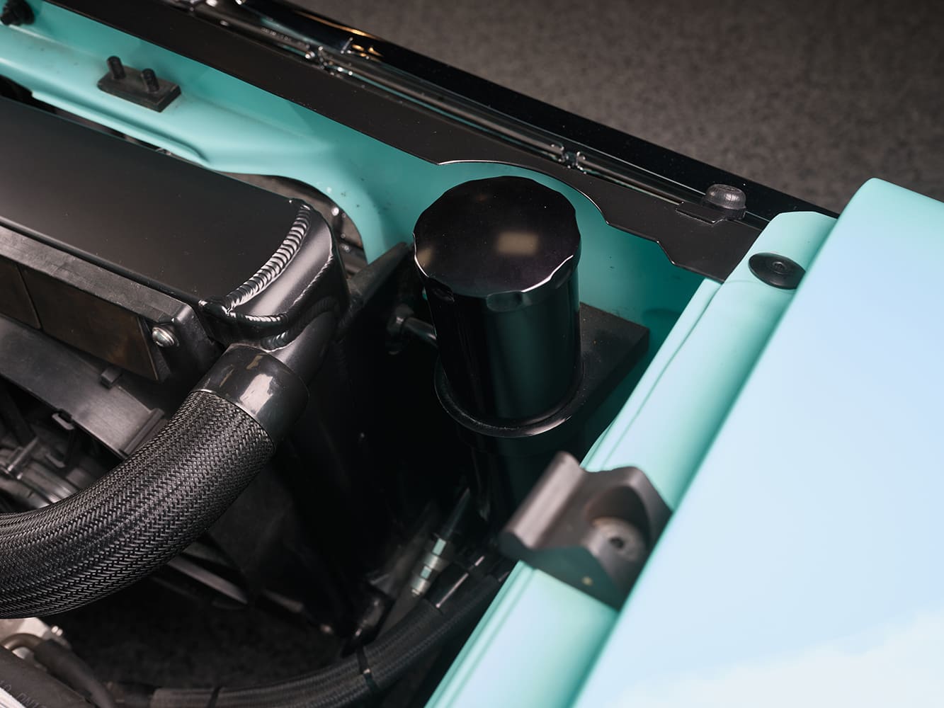 09 1963 Ford Falcon custom radiator setup with braided hoses and black aluminum reservoir