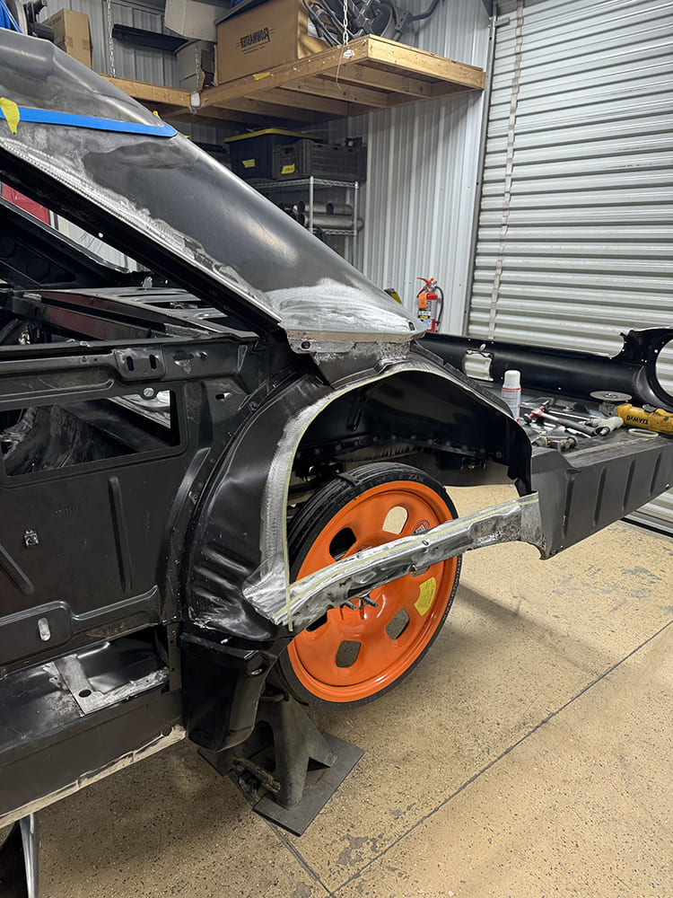 11 1963 Galaxie quarter panel edge trimmed and prepped for welding with visible replacement arch