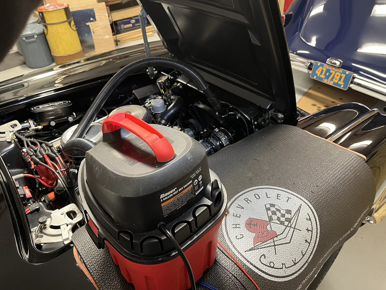 13 Corvette fender cover with shop vac during fan controller install on classic Chevrolet