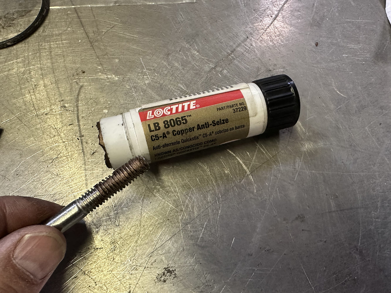 13 Loctite LB 8065 copper anti seize being applied to bracket bolt threads