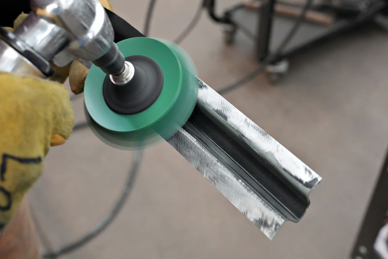 13 echnician grinding weld edges clean on a Challenger A pillar using a rotary sanding disc