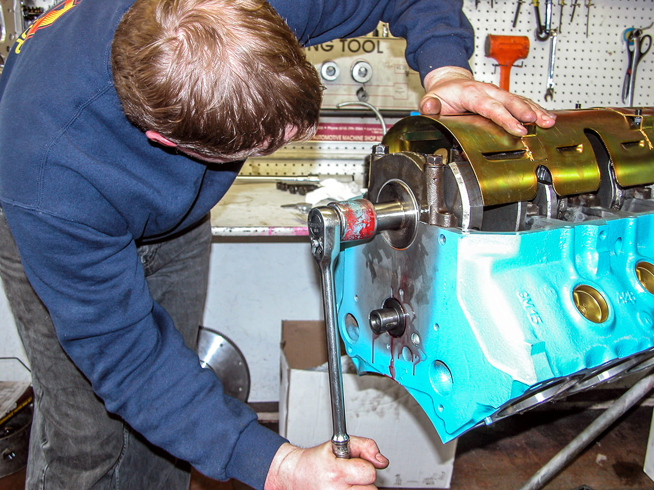 14 Bolting windage tray in place as part of Pontiac 428 bottom end prep