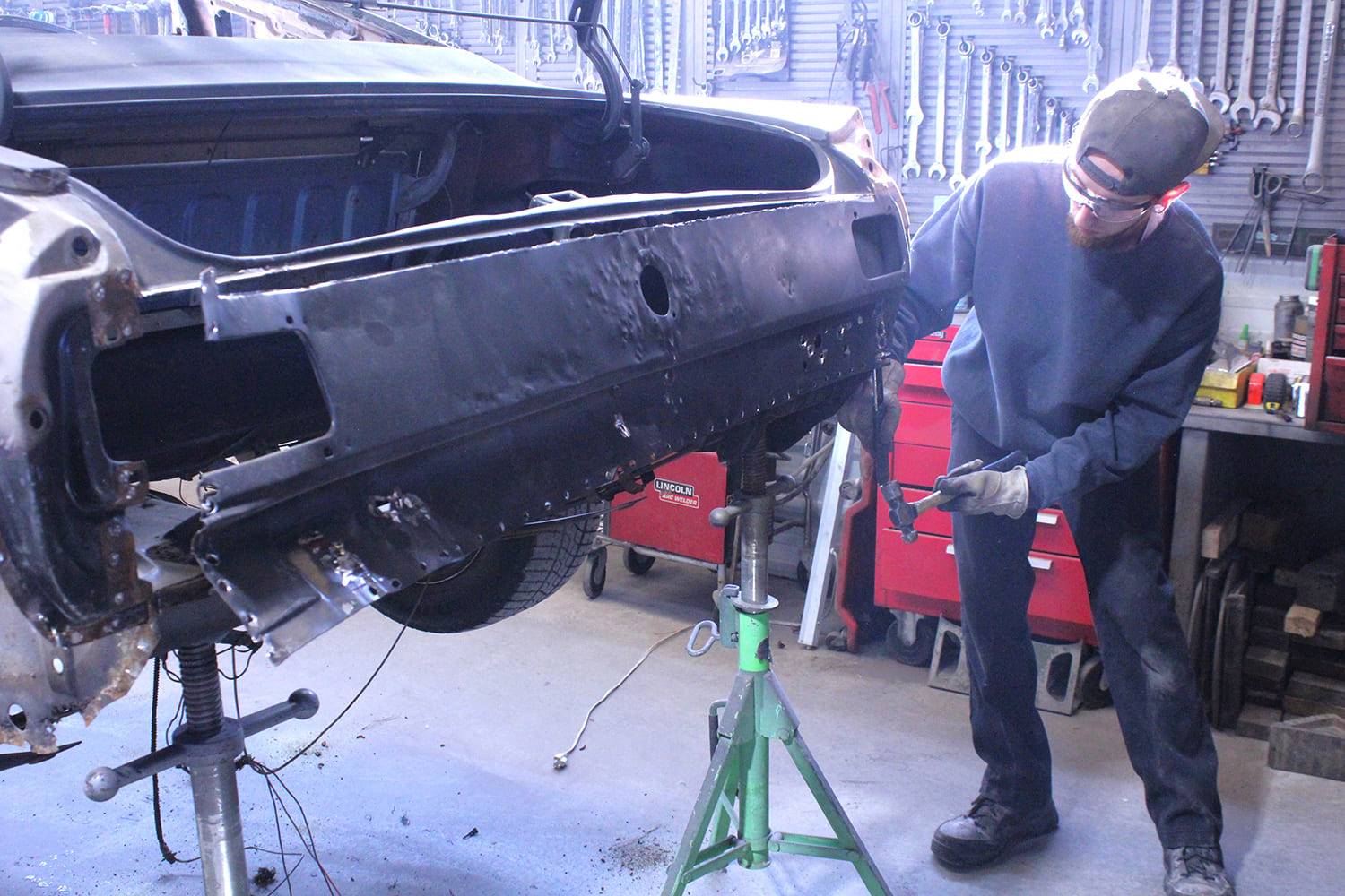 14 removing damaged 1965 mustang tail panel with hammer and chisel