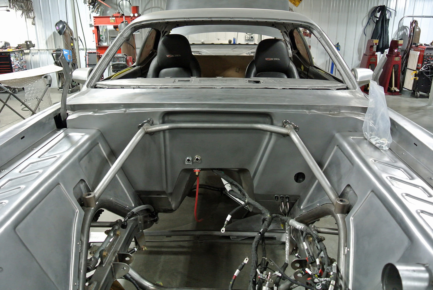 16 Weld in firewall tubing reinforcement tied into roll cage and shock towers