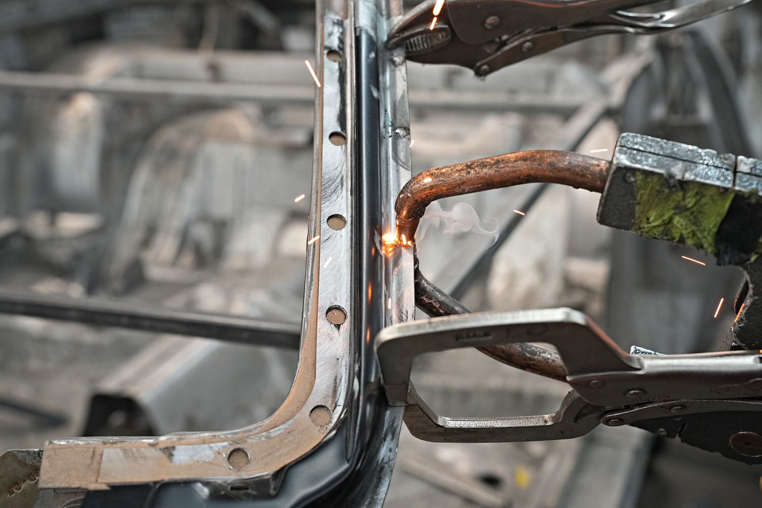 17 MIG welder applying plug welds to secure new A pillar section on 1971 Dodge Challenger