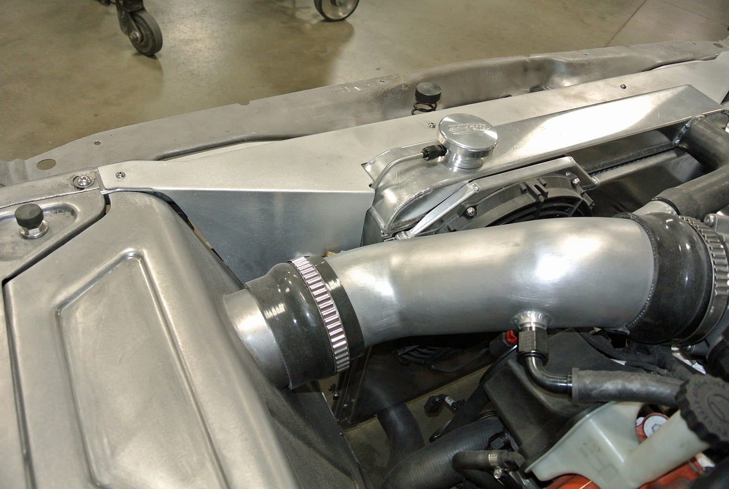 20 Intake tube fitted into custom fabricated shroud beside dual fan aluminum radiator