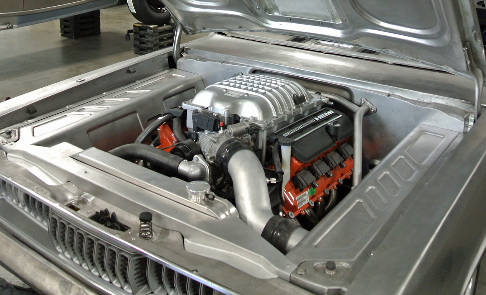 21 1971 Plymouth Duster features a modern Hellcat HEMI swap with fully custom bead rolled engine bay panels and bracing