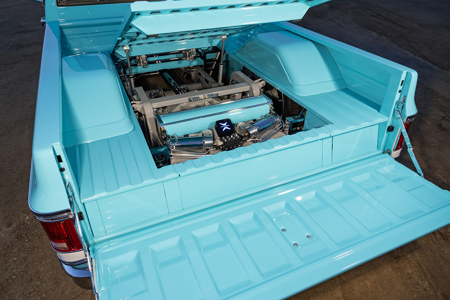 22 1973 Chevy C10 raised bed floor reveals air suspension setup with custom cover